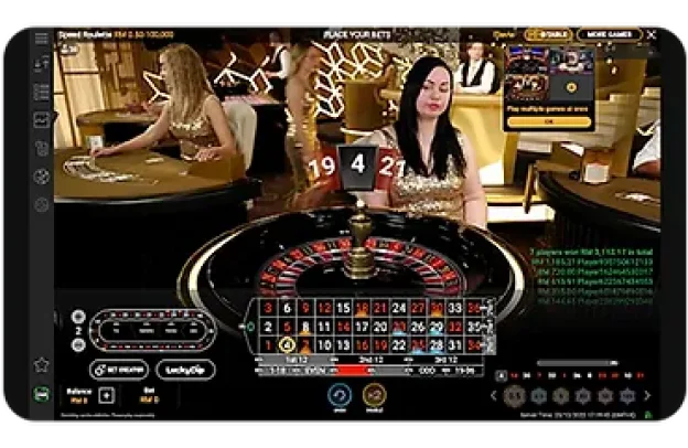 Meja Speed Roulette dengan peniaga, menunjukkan roda roulette dan pilihan pertaruhan.